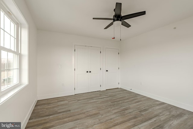 unfurnished bedroom featuring ceiling fan and light hardwood / wood-style flooring