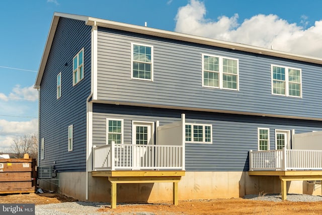 rear view of house featuring a wooden deck