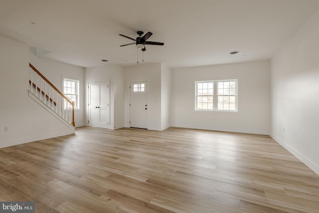 unfurnished living room featuring ceiling fan, light hardwood / wood-style floors, and a healthy amount of sunlight