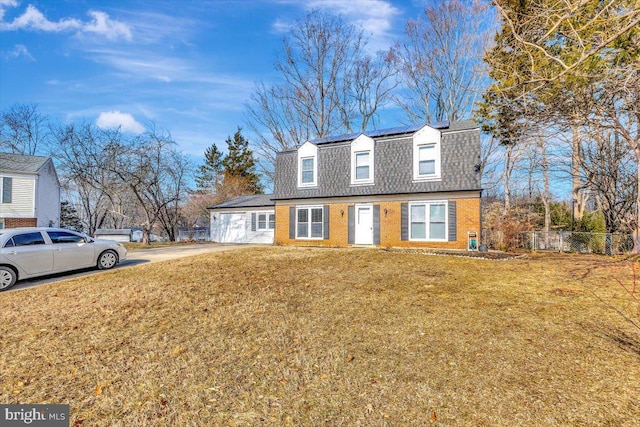 cape cod home featuring a front lawn