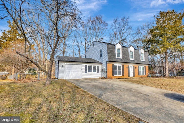 cape cod home with a garage and a front lawn