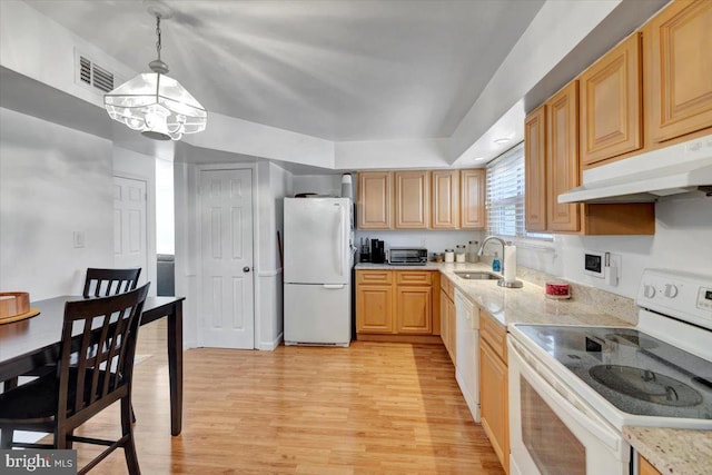 kitchen featuring light wood-type flooring, light brown cabinetry, white appliances, and decorative light fixtures