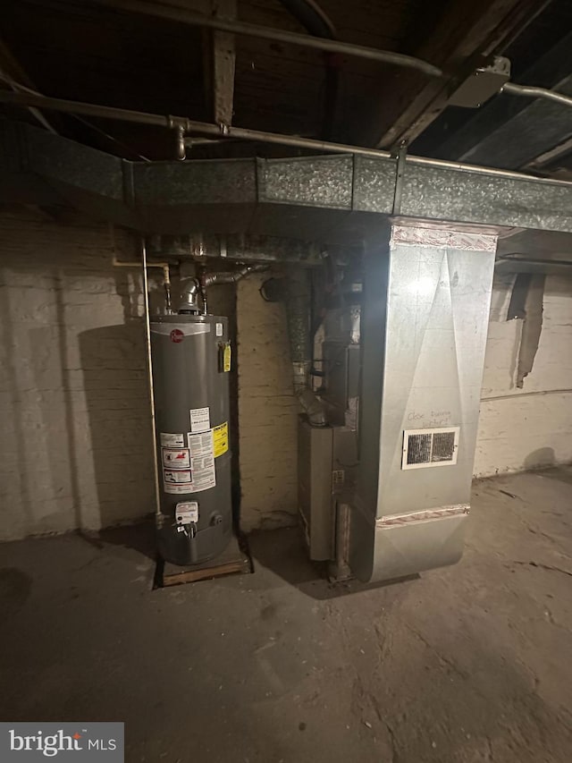 utility room with gas water heater and heating unit