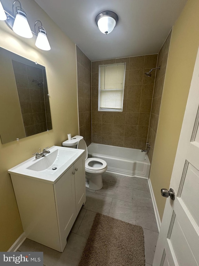 full bathroom featuring tiled shower / bath combo, vanity, and toilet