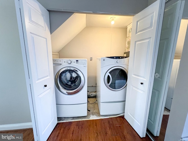 washroom featuring dark wood-type flooring and washing machine and clothes dryer