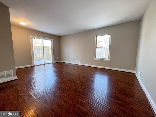 spare room with dark hardwood / wood-style floors