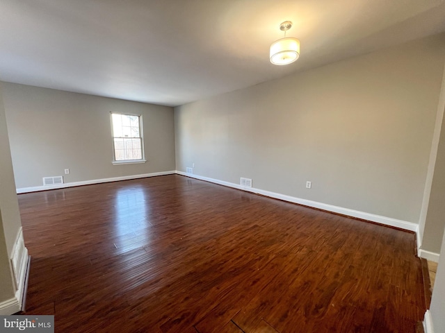 spare room featuring dark hardwood / wood-style floors