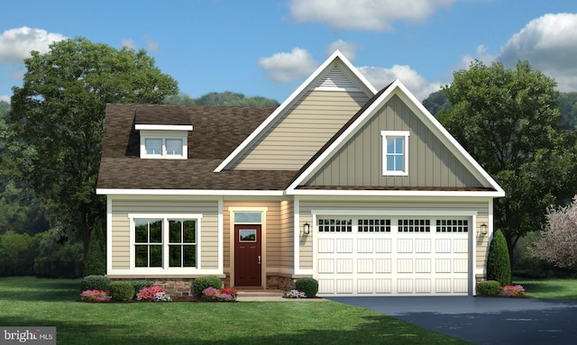 view of front of property featuring a garage and a front lawn