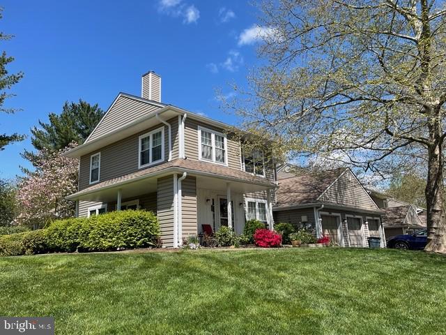 view of side of property featuring a garage and a yard