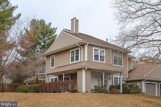 view of front of property featuring a garage and covered porch