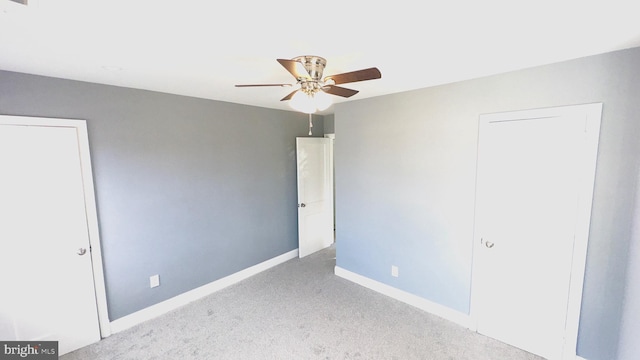 unfurnished bedroom featuring light colored carpet and ceiling fan