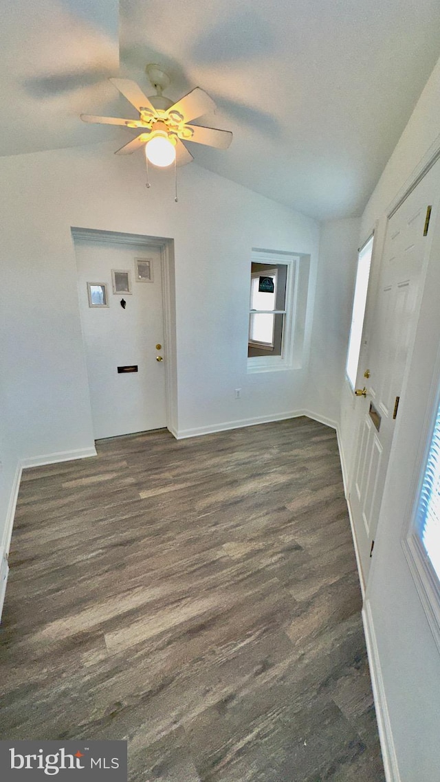 foyer featuring vaulted ceiling, dark hardwood / wood-style floors, and ceiling fan