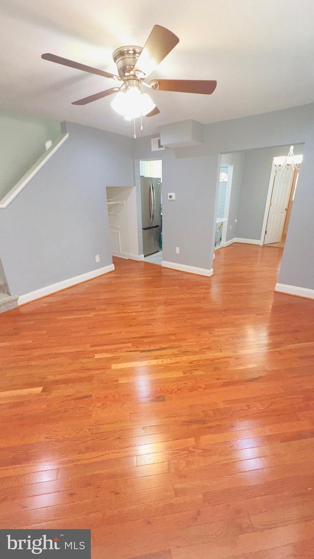 unfurnished living room featuring ceiling fan and light hardwood / wood-style flooring