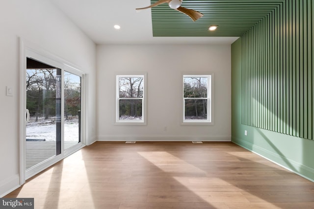 spare room with light hardwood / wood-style floors and ceiling fan