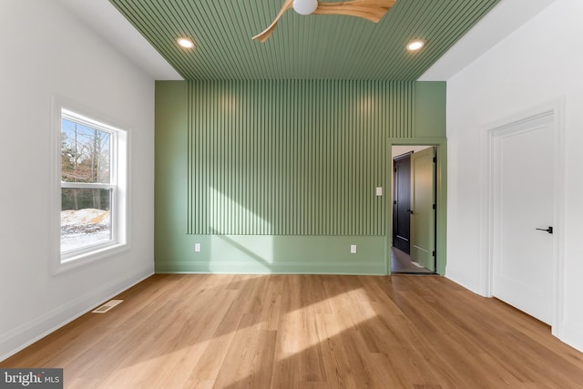 spare room featuring wood ceiling, ceiling fan, and light hardwood / wood-style floors