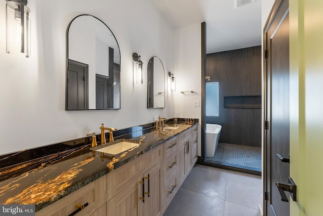 bathroom with tile patterned floors, vanity, and a bathing tub