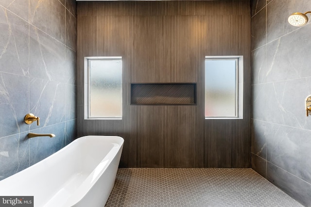 bathroom featuring a tub to relax in and tile patterned floors