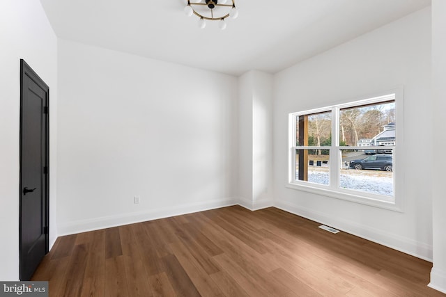 unfurnished room with hardwood / wood-style floors