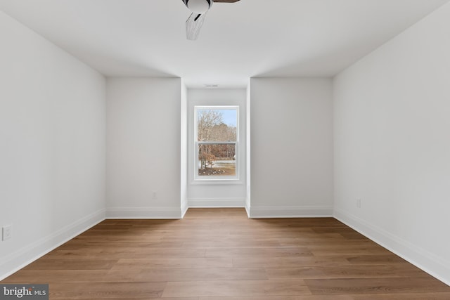 empty room with ceiling fan and light wood-type flooring