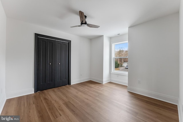 unfurnished bedroom with ceiling fan and light hardwood / wood-style floors