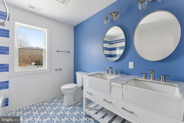 bathroom featuring vanity, tile patterned floors, and toilet