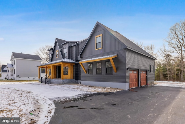 modern farmhouse style home with a garage and covered porch