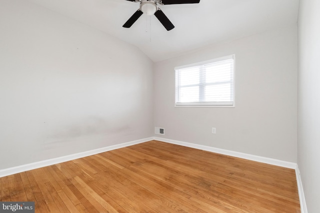 spare room featuring hardwood / wood-style flooring, ceiling fan, and lofted ceiling