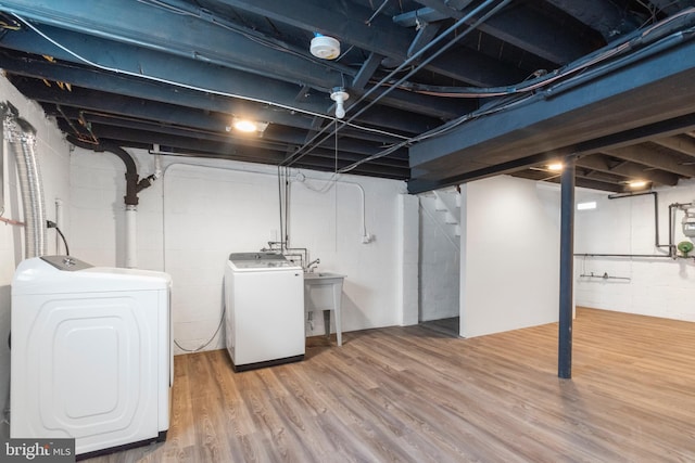 basement featuring hardwood / wood-style floors and washer and dryer