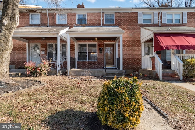 townhome / multi-family property featuring a porch