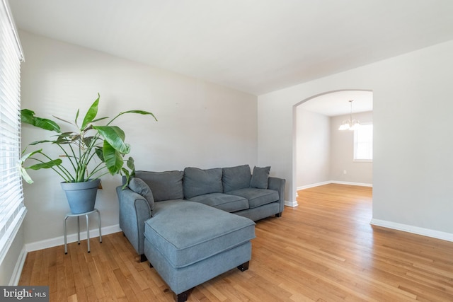 living room featuring an inviting chandelier and hardwood / wood-style floors