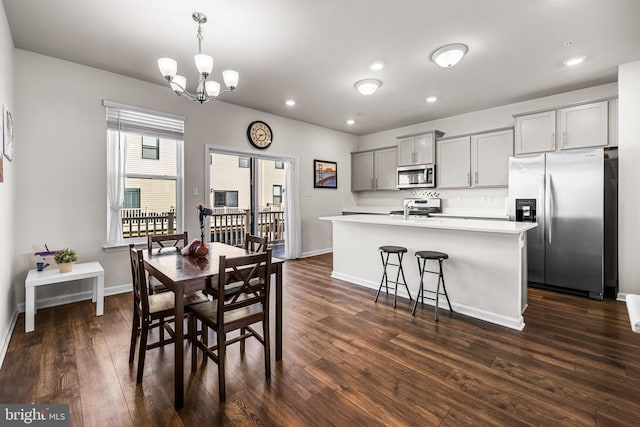 dining room with an inviting chandelier and dark hardwood / wood-style flooring