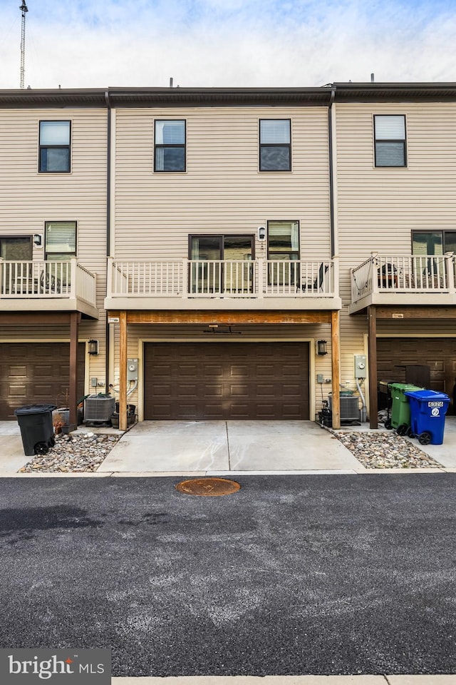 multi unit property featuring cooling unit and a garage