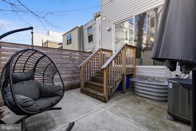 wooden terrace featuring a patio and central air condition unit