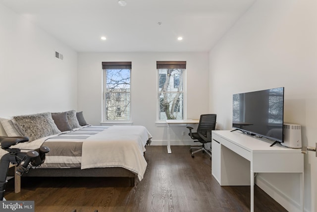 bedroom with dark hardwood / wood-style flooring