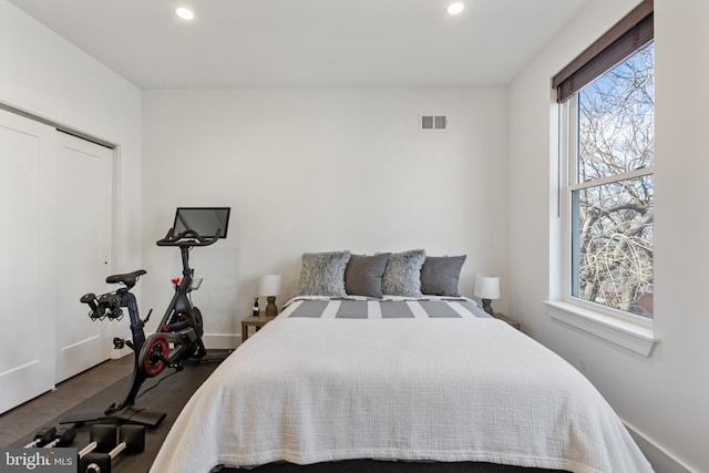 bedroom with hardwood / wood-style floors and a closet