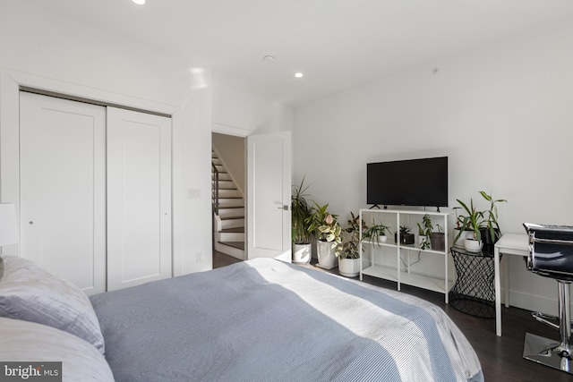 bedroom featuring dark hardwood / wood-style flooring and a closet