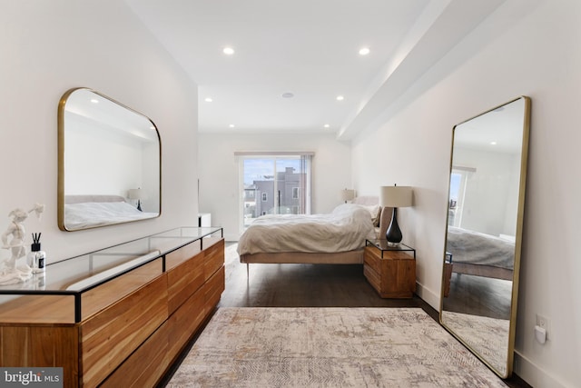 bedroom with dark hardwood / wood-style floors