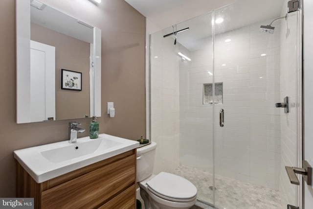 bathroom with vanity, toilet, and walk in shower