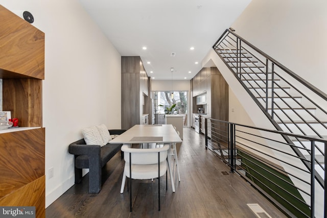 dining space with dark hardwood / wood-style flooring