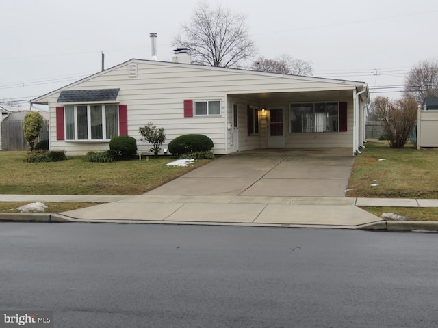 ranch-style home with a carport and a front lawn