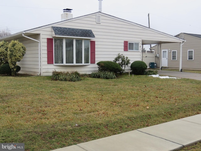 view of property exterior with a lawn and a carport