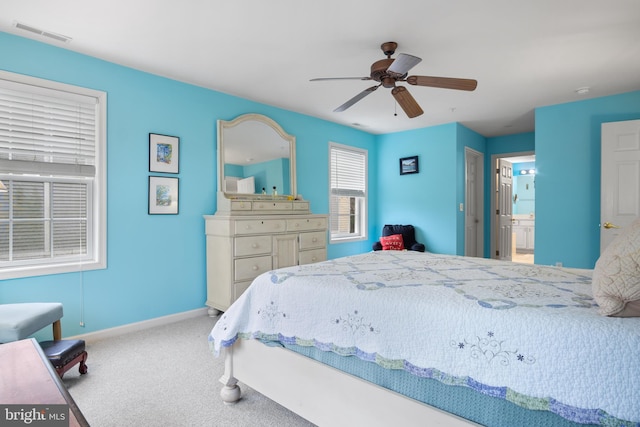 bedroom featuring ensuite bathroom, ceiling fan, and carpet flooring