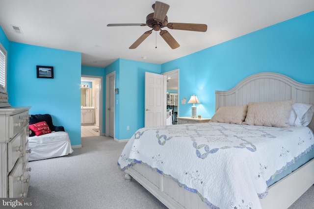 carpeted bedroom with connected bathroom and ceiling fan