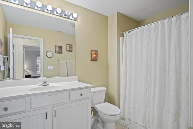 bathroom with vanity, tile patterned floors, and toilet