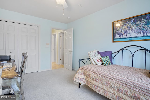 carpeted bedroom featuring ceiling fan and a closet