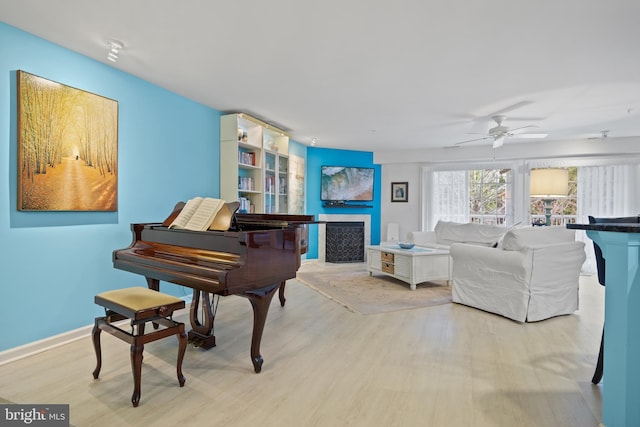 misc room featuring ceiling fan and light wood-type flooring