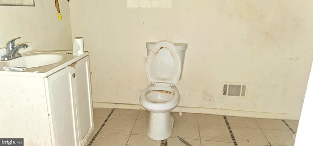 bathroom featuring tile patterned flooring, vanity, and toilet