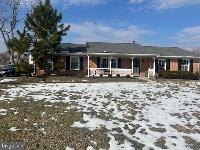 ranch-style house with a porch and brick siding