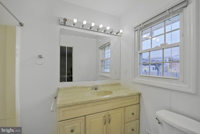 bathroom featuring vanity and toilet