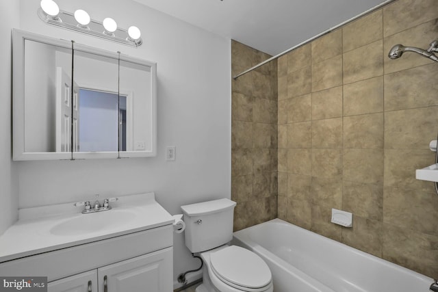 bathroom with tub / shower combination, vanity, and toilet